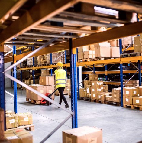 woman-warehouse-worker-with-hand-forklift-truck-PLH9ZG2.jpg